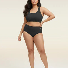 Woman wearing a black bra and  underwear set on a beige background