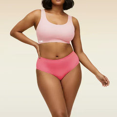Woman wearing a pink underwear set on a beige background