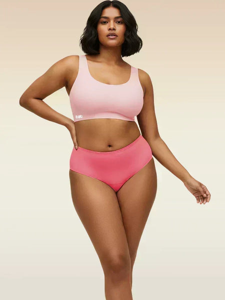 Woman wearing a pink underwear set on a beige background