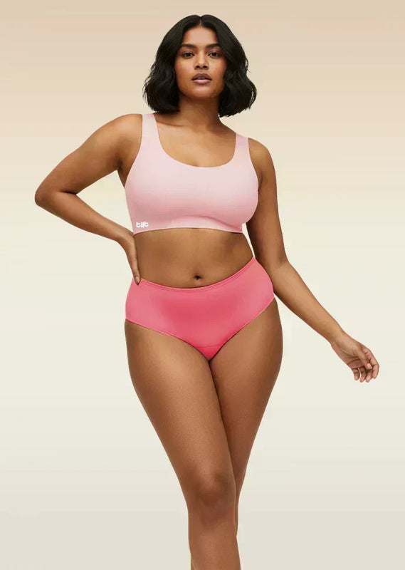Woman wearing a pink underwear set on a beige background