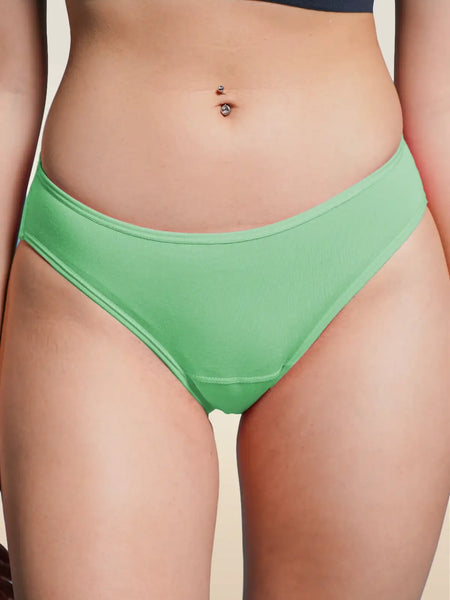 Green underwear worn by a person on a beige background
