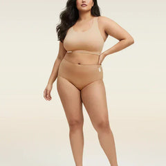 Woman wearing a beige bra and  underwear set on a beige background