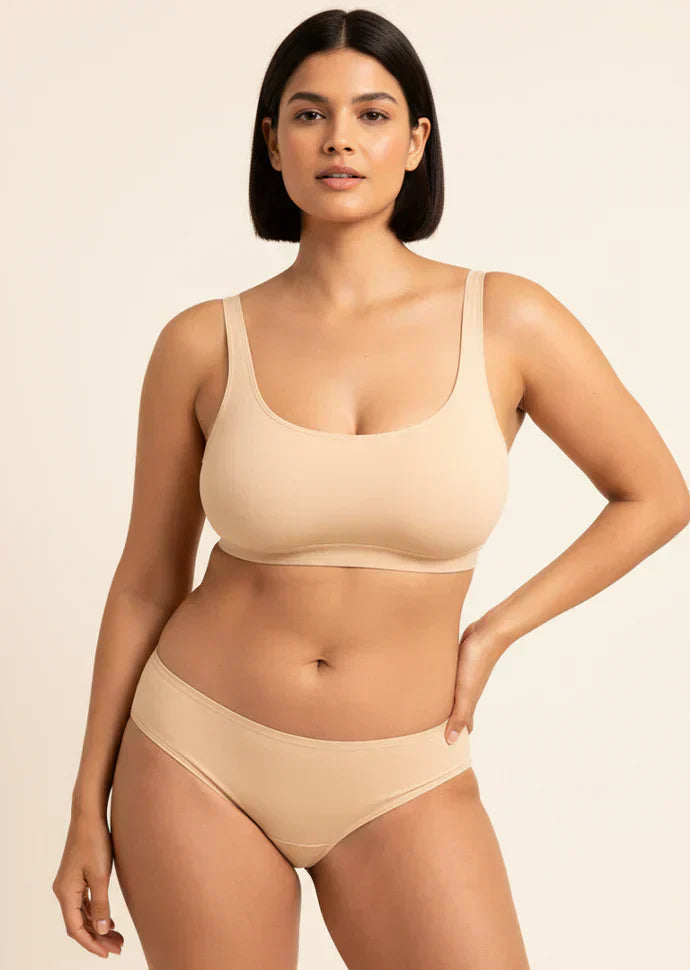 Woman wearing a beige bra and panties  on a beige background