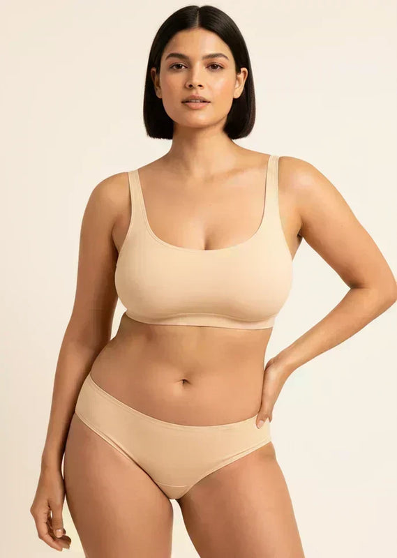 Woman wearing a beige bra and panties  on a beige background