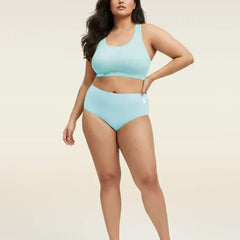 Woman wearing a blue bra and underwear set on a beige background