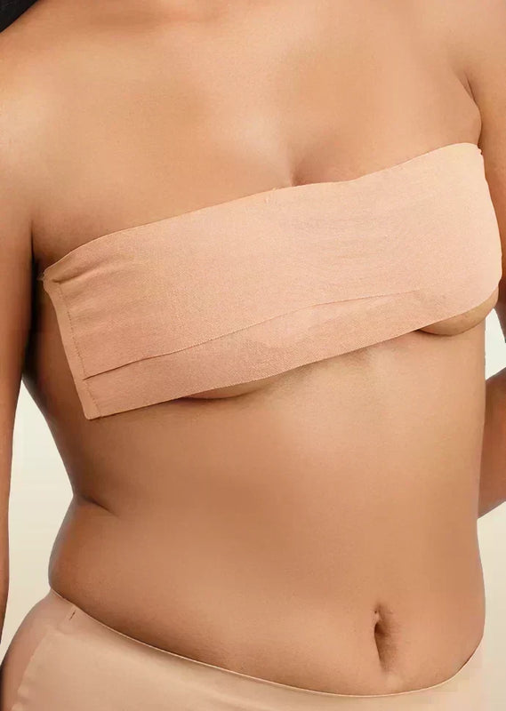 Beige boob tape worn by a person on a beige background