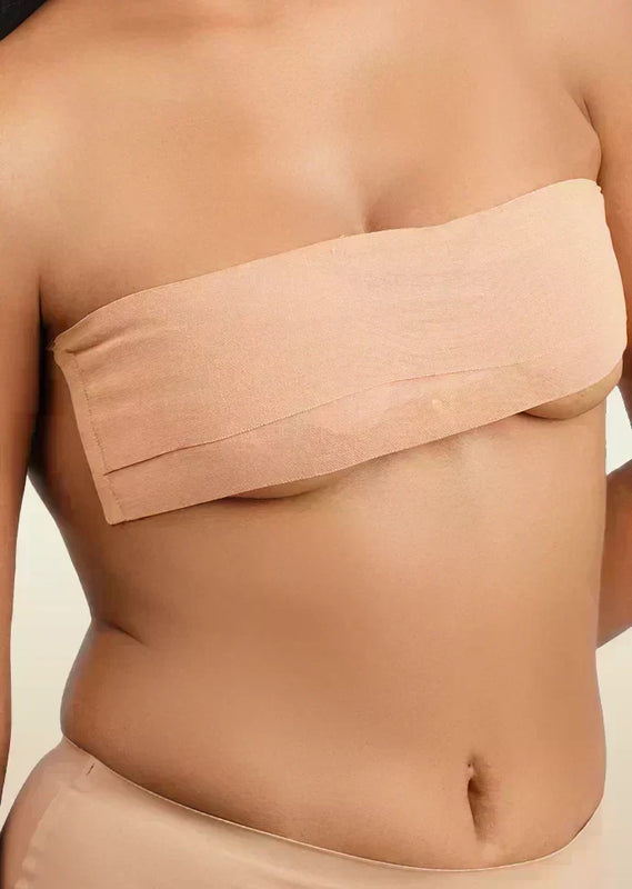 Beige boob tape worn by a person on a beige background