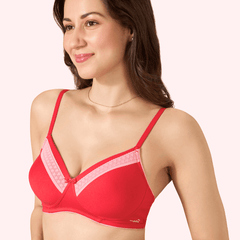 Woman wearing a red bra with pink accents on a white background