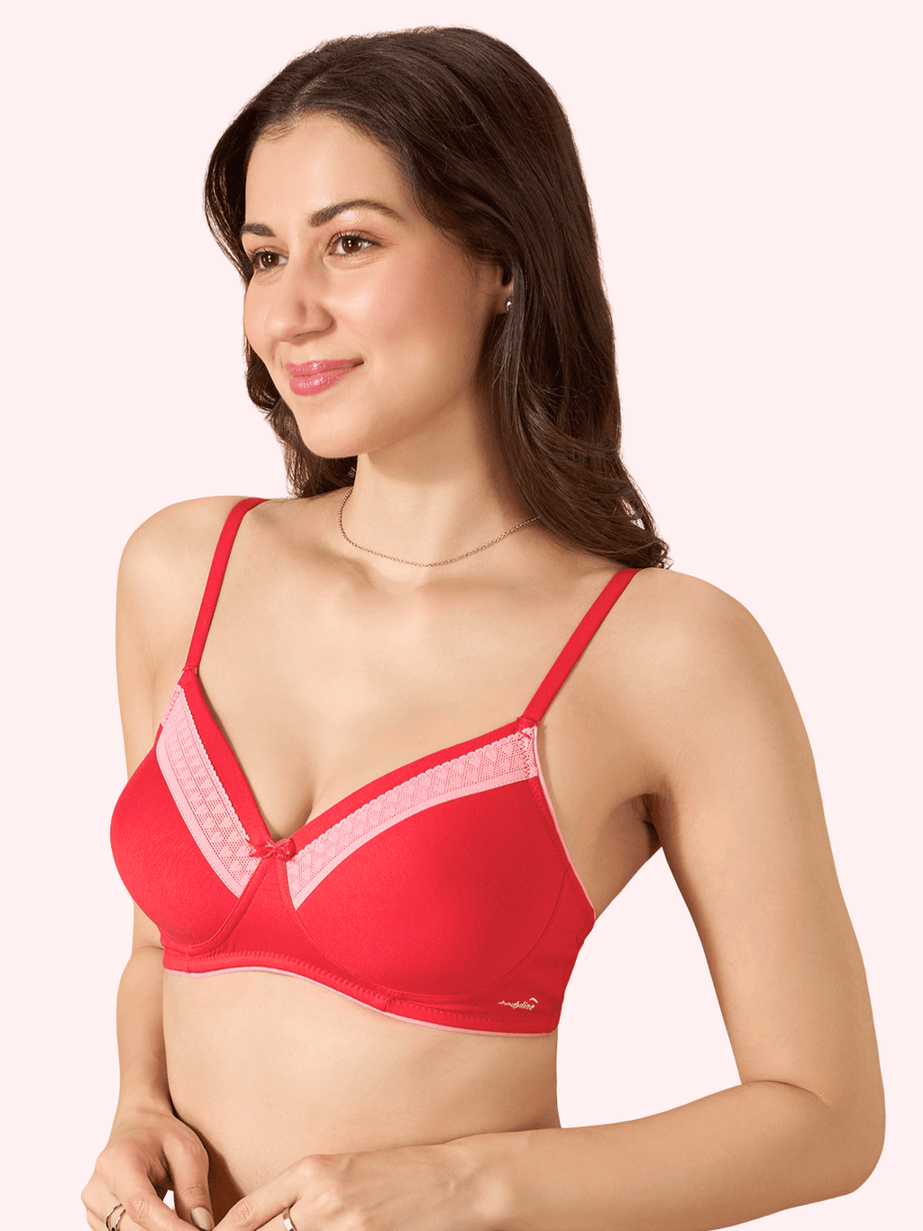 Woman wearing a red bra with pink accents on a white background