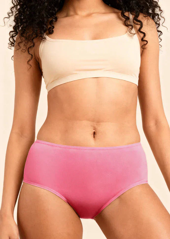 Person wearing a beige bra and pink underwear on a neutral background
