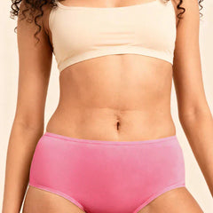Person wearing a beige bra and pink underwear on a neutral background