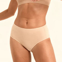 Beige mid-waist underwear on a plain background