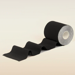 Roll of black tape on a beige background