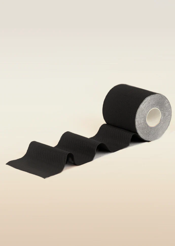 Roll of black tape on a beige background
