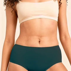 Person wearing a beige sports bra and teal mid-waist underwear on a neutral background