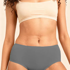 Person wearing a beige bra and gray underwear on a beige background