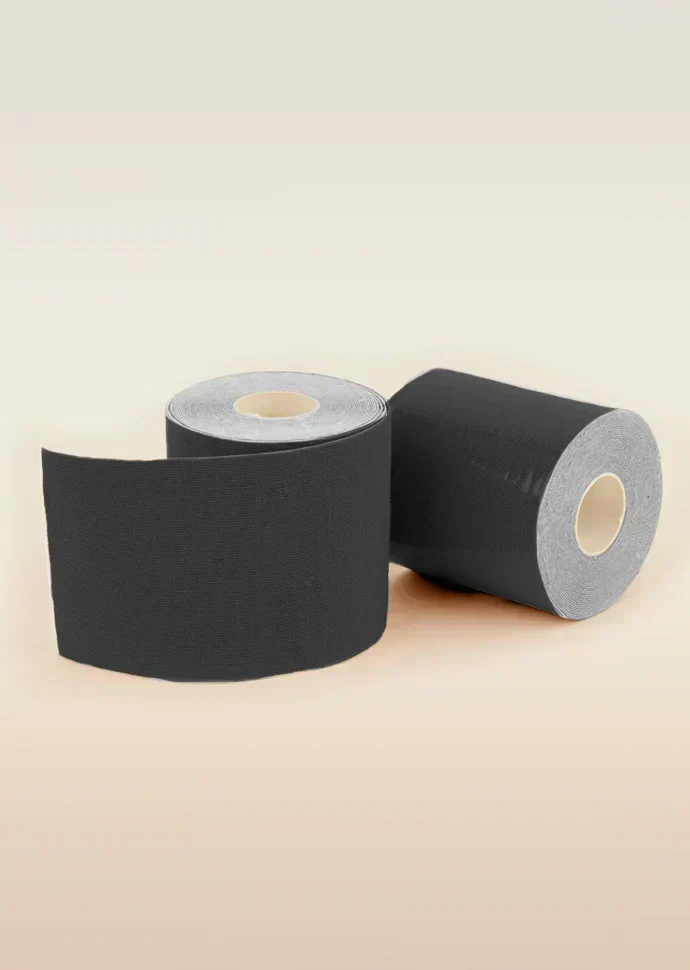 Two rolls of black tape on a beige background