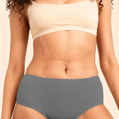Person wearing a beige bra and gray underwear on a beige background