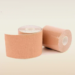 Two rolls of beige boob tape on a beige background