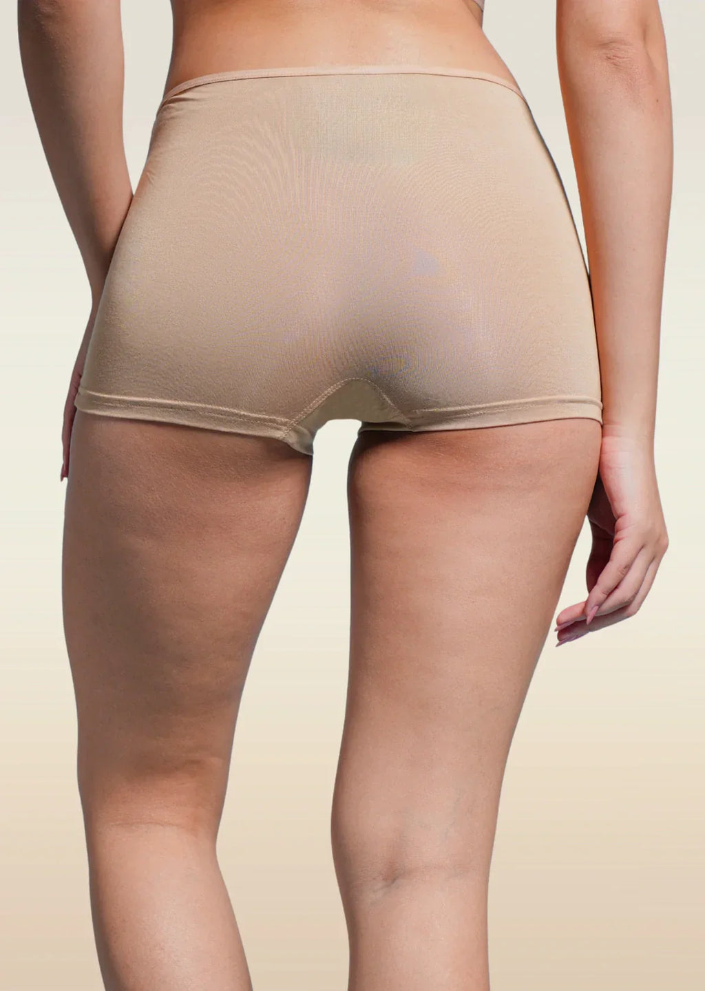 Beige boyshorts worn by a person on a beige background