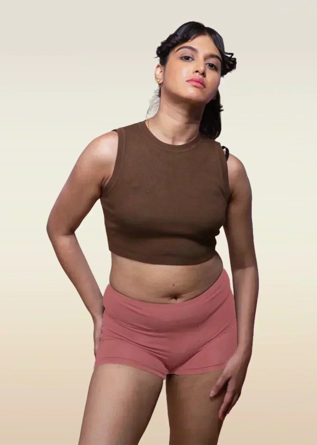 person wearing a brown sleeveless crop top and red boyshort style underwear.