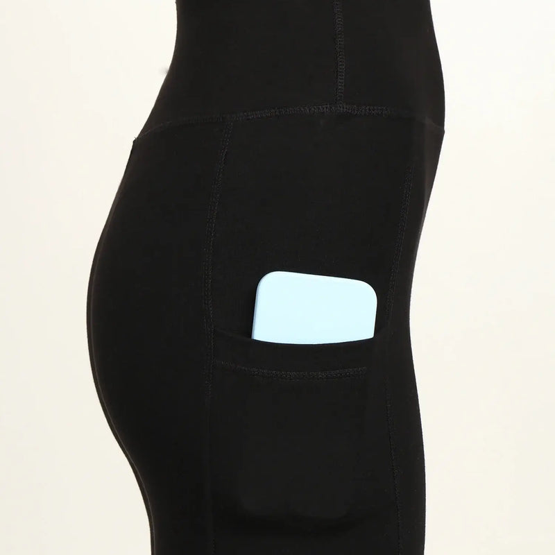 Side view of high-waist bamboo yoga pants with pocket, featuring a phone tucked inside for convenience and style.