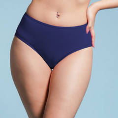 Person wearing navy blue high-waisted underwear on a light blue background