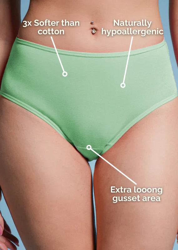 Green underwear with text highlighting features on a blue background