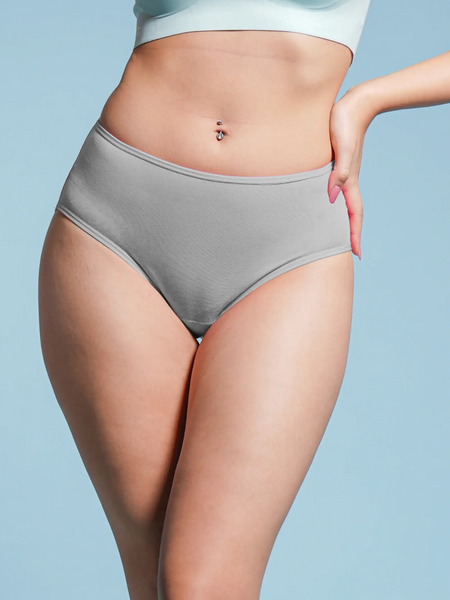 Person wearing gray underwear against a light blue background
