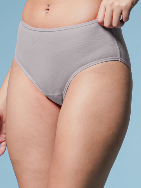 Person wearing gray underwear against a light blue background