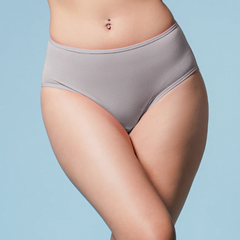Person wearing a pair of gray brief underwear against a light blue background