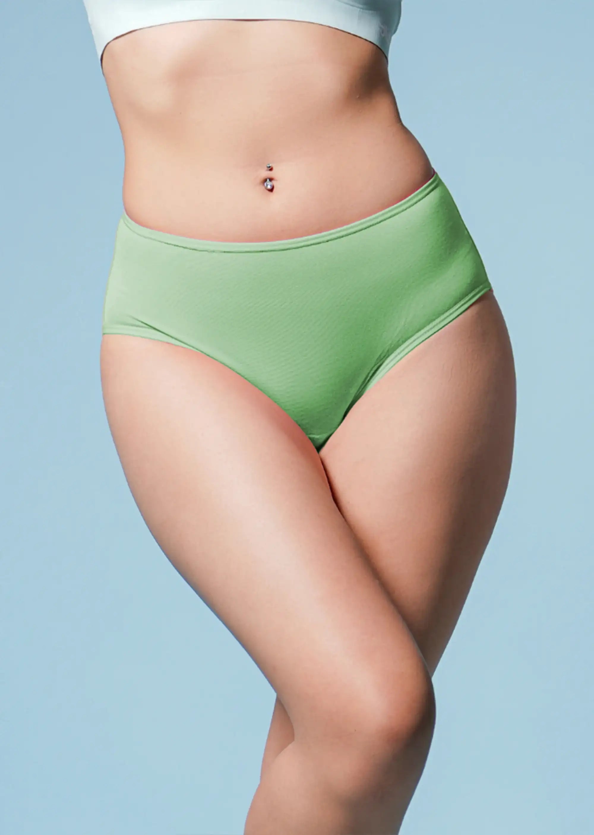 Green high-waisted underwear worn by a person on a light blue background
