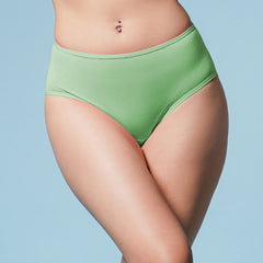 Person wearing green underwear against a light blue background