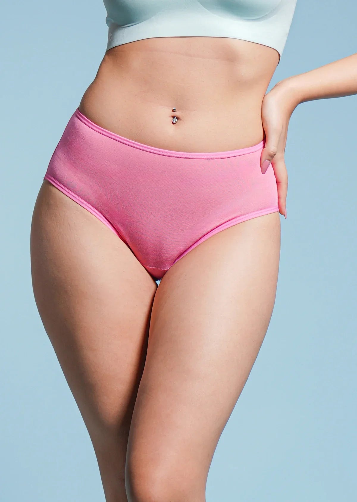 Person wearing pink underwear against a light blue background