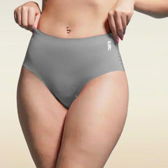 Person wearing gray underwear with a beige background