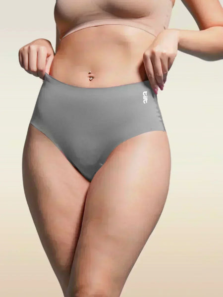Person wearing gray underwear with a beige background