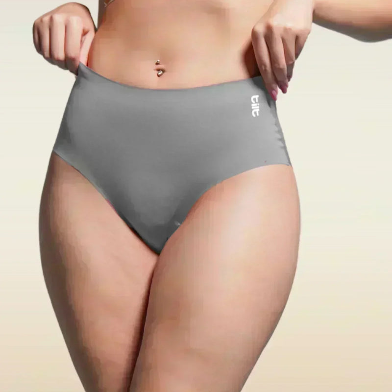 Person wearing gray underwear with a beige background