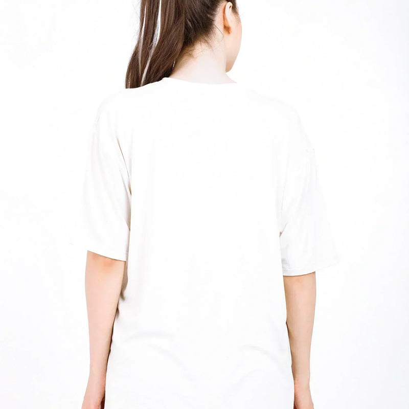 Back view of a woman wearing an oversized bamboo t-shirt, showcasing its loose fit and soft fabric.