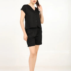 Model wearing Women's Modal Satin Night Suit in black, featuring a soft shirt and shorts for ultimate comfort.