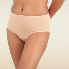 Person wearing beige mid-waist underwear on a plain background
