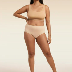 Woman wearing a beige bra and underwear set on a beige background