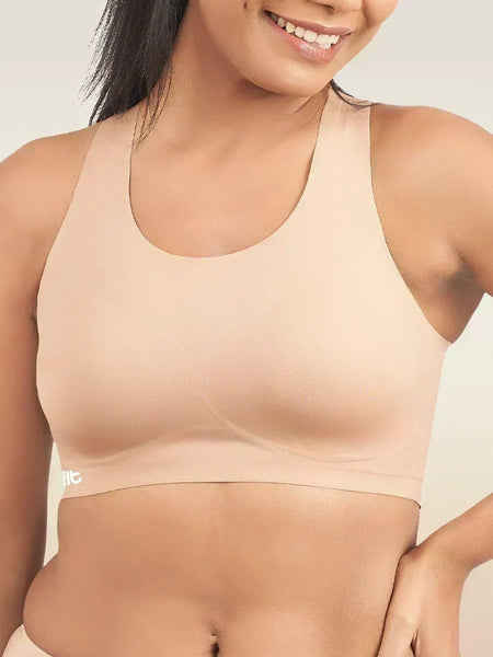 Beige sports bra worn by a person on a plain background