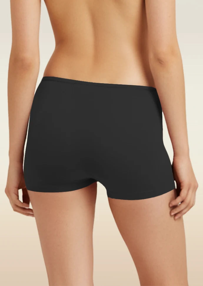 Black boyshort underwear worn by a person on a beige background