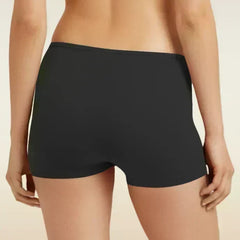 Black boyshort underwear worn by a person on a beige background