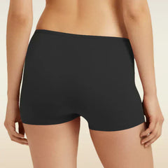 Black boyshort underwear worn by a person on a beige background