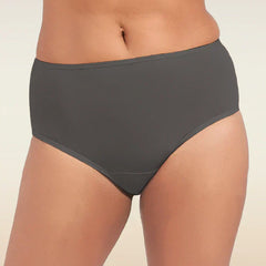 Person wearing dark gray mid-waist  underwear on a beige background