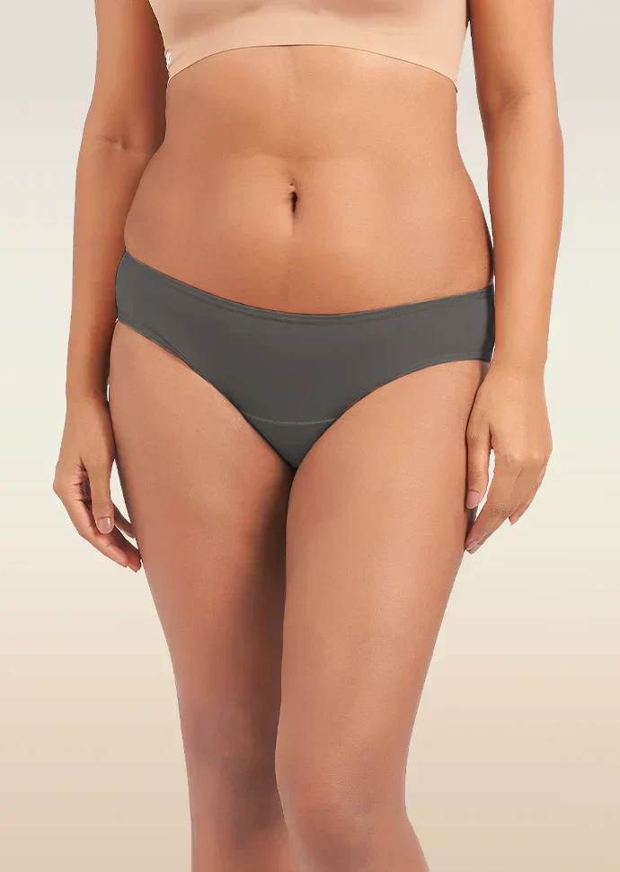 Person wearing gray underwear on a beige background