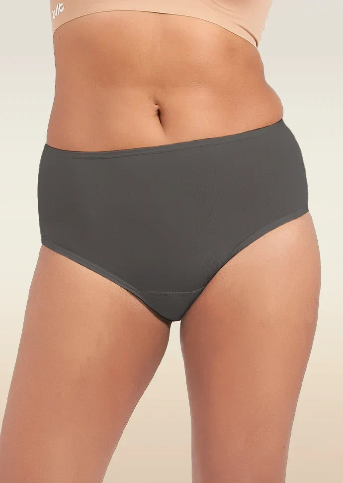 Person wearing dark gray mid-waist  underwear on a beige background